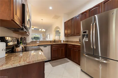 a large kitchen with a table and chairs