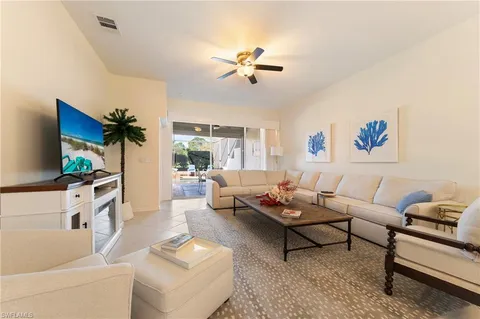 a living room with furniture and view of kitchen