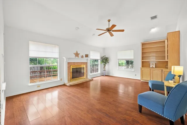 a view of livingroom with furniture a fireplace and wooden floor
