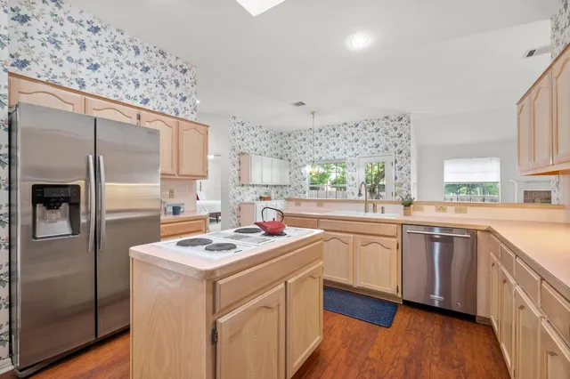 a kitchen with a sink stove and refrigerator