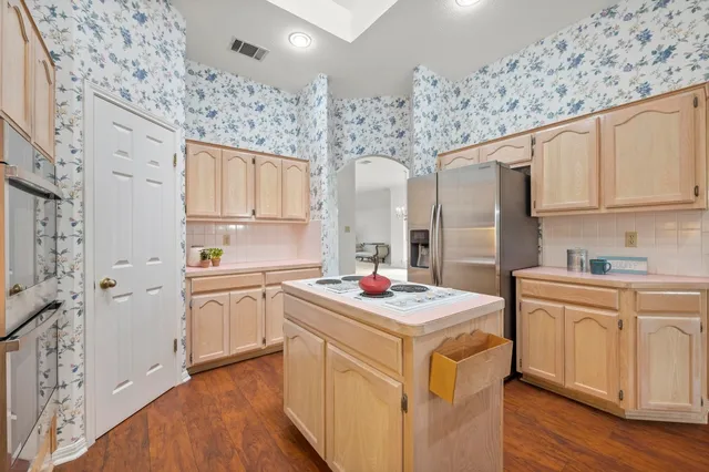 a kitchen with a sink stove and refrigerator