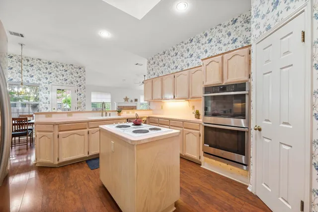 a kitchen with a sink stove and refrigerator