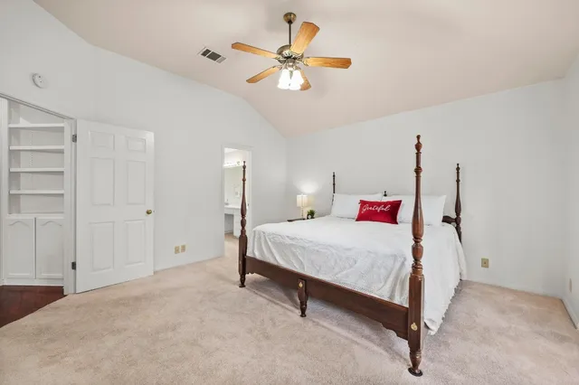a bedroom with a bed and a ceiling fan