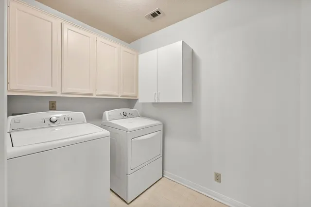 a view of storage and utility room with washer and dryer
