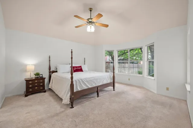 a bed room with a bed and a chandelier
