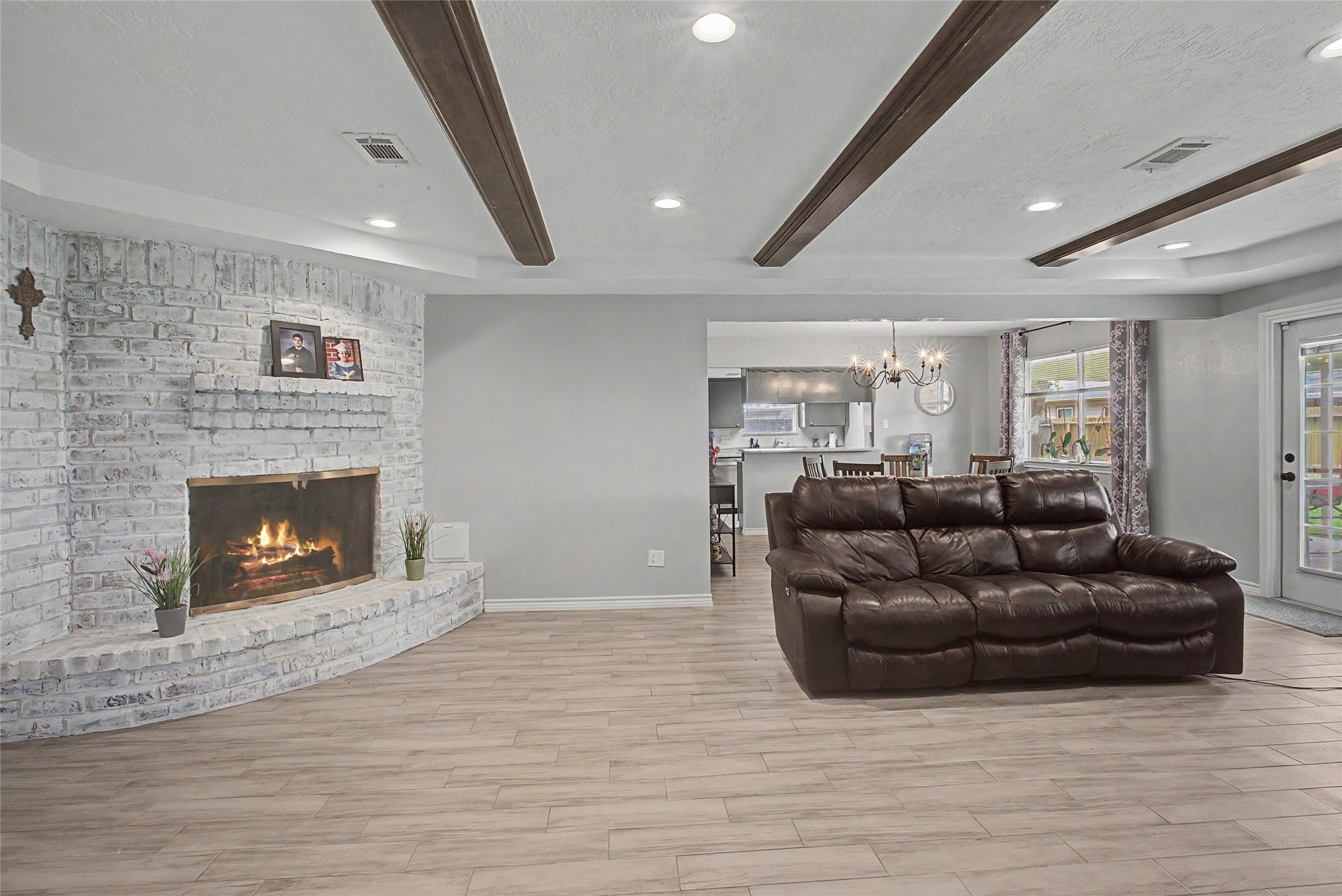 327 Fir Ridge Drive Huffman, TX 77336 - Photo 6 of 25 Large Corner Fireplace is the heart of your family room. Updated with New recessed light fixtures in 2022 The home has Ceramic tile floors throughout installed 2022.