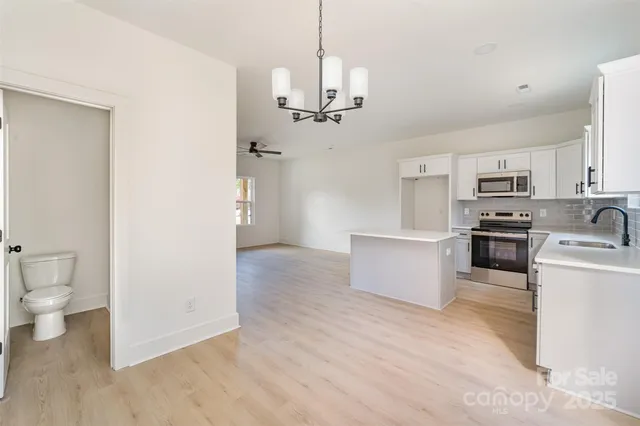 a view of a kitchen with stove and refrigerator