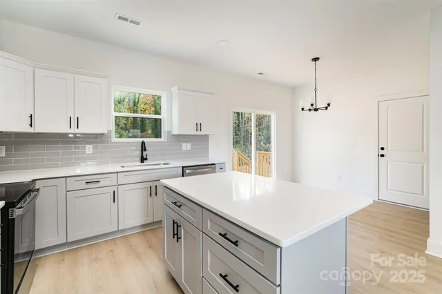 a kitchen with a sink stove and cabinets