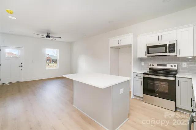 a bathroom with a granite countertop toilet sink and mirror