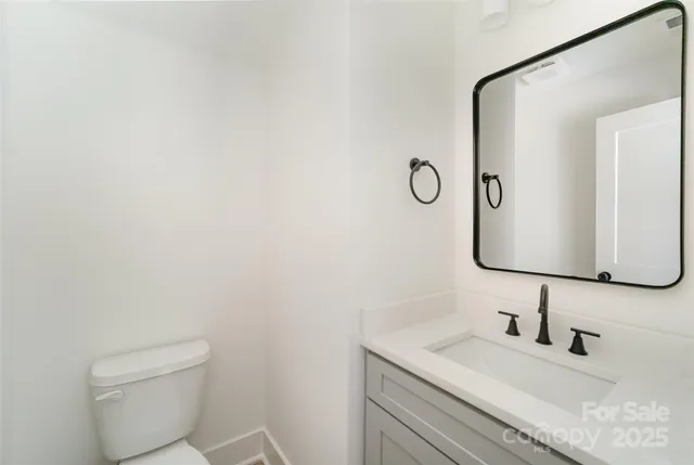 an empty room with chandelier fan