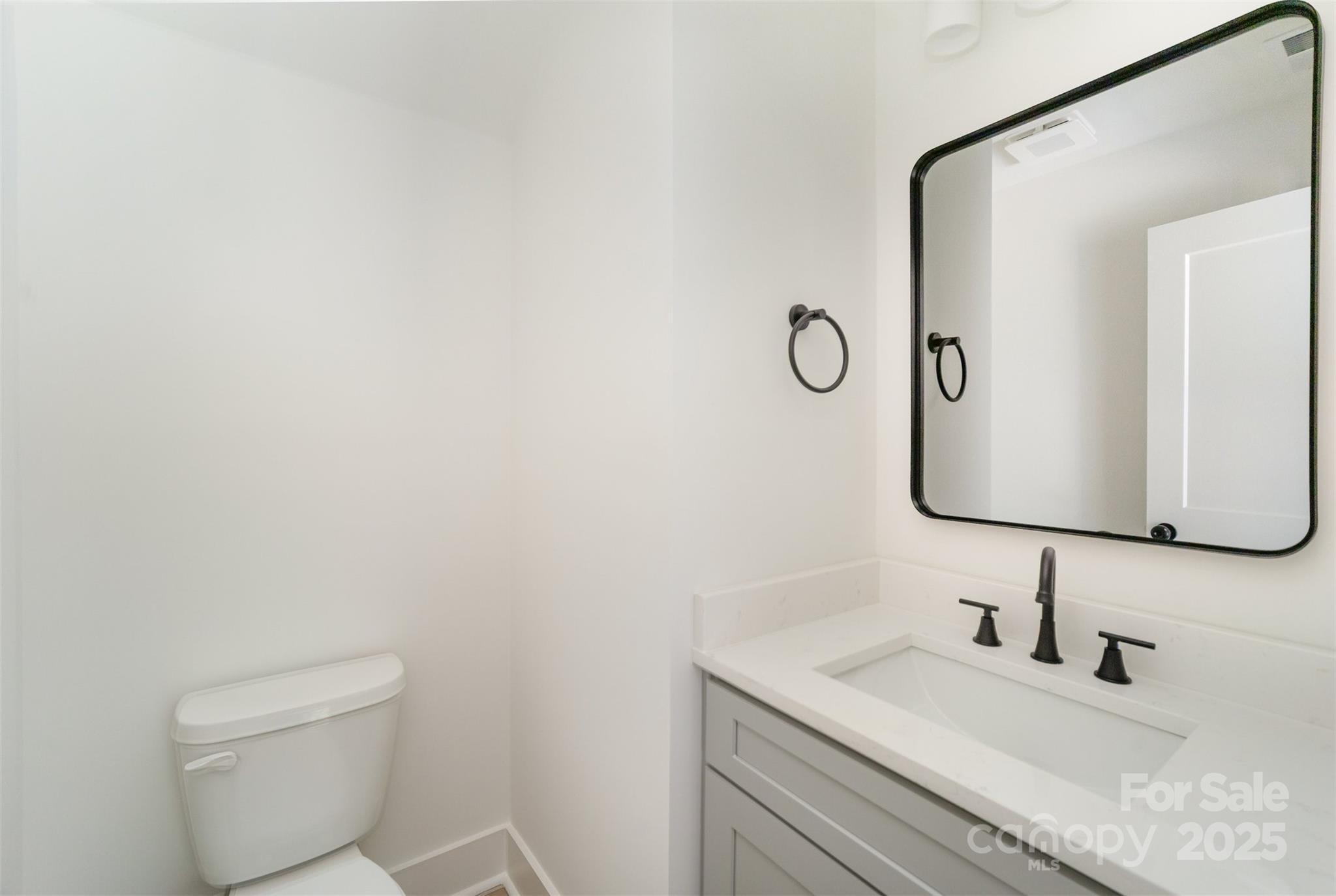 604 6th St Court Northwest Conover, NC 28613 - Photo 16 of 31 a bathroom with a granite countertop toilet sink and mirror