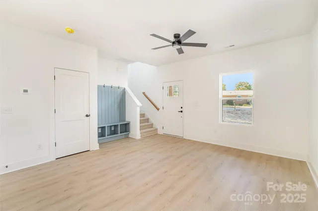 a view of a livingroom with a ceiling fan and window