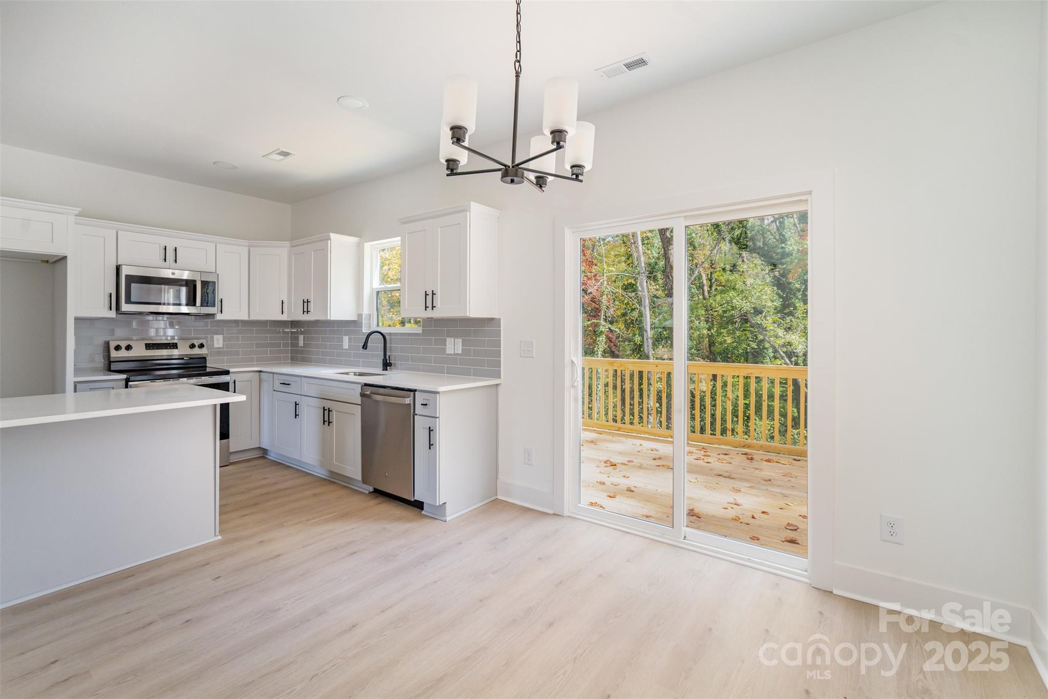 604 6th St Court Northwest Conover, NC 28613 - Photo 10 of 31 a kitchen with a stove a sink and a microwave