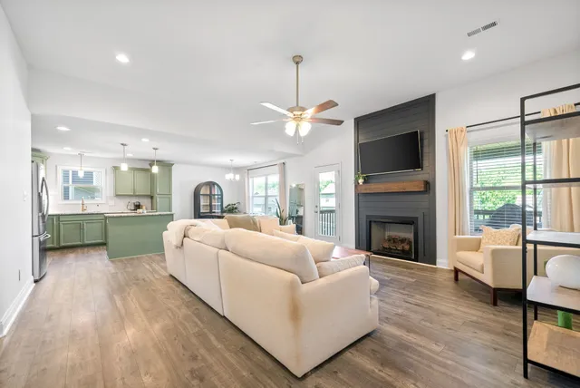 a living room with furniture fireplace and a flat screen tv