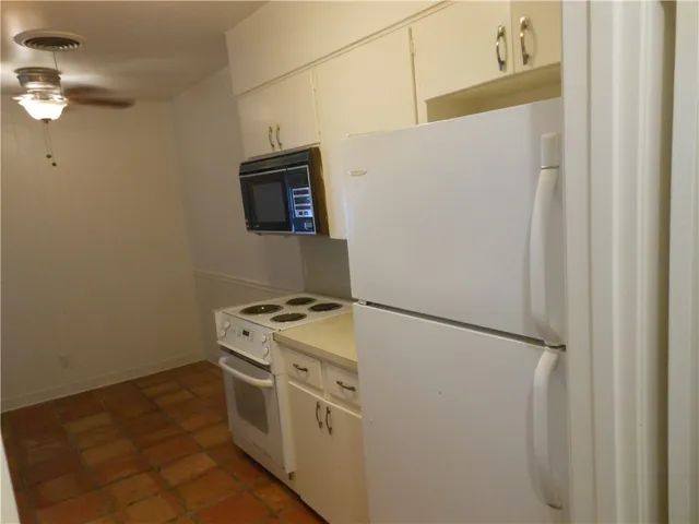 a kitchen with a stove and a refrigerator