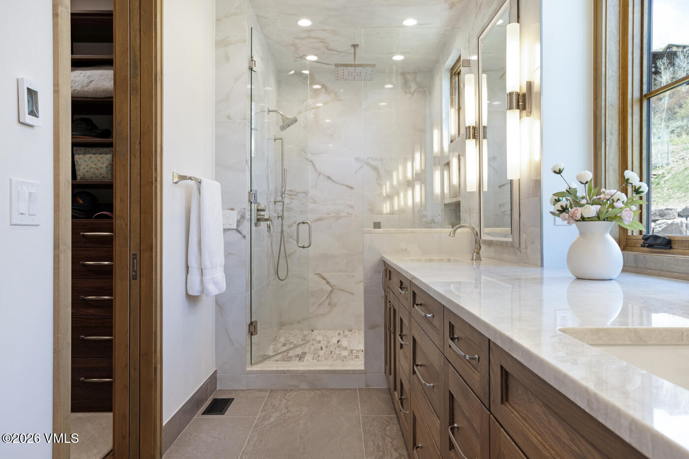 5205 Long Sun Lane Avon, CO 81620 - Photo 12 of 35 a bathroom with a granite countertop sink a large mirror and shower