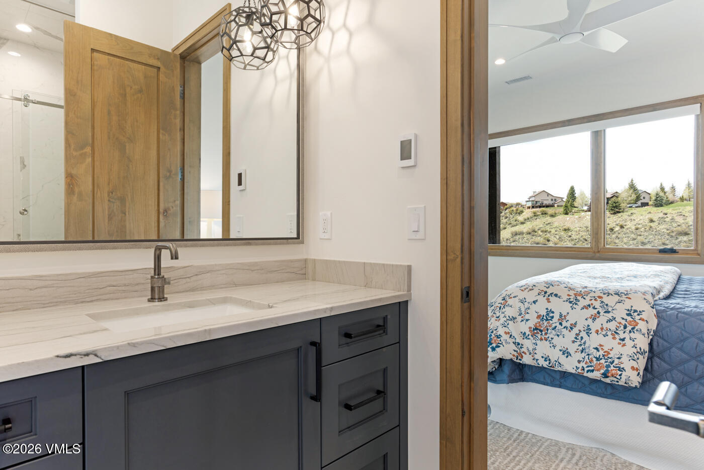 5205 Long Sun Lane Avon, CO 81620 - Photo 31 of 35 a bathroom with a granite countertop sink and a mirror
