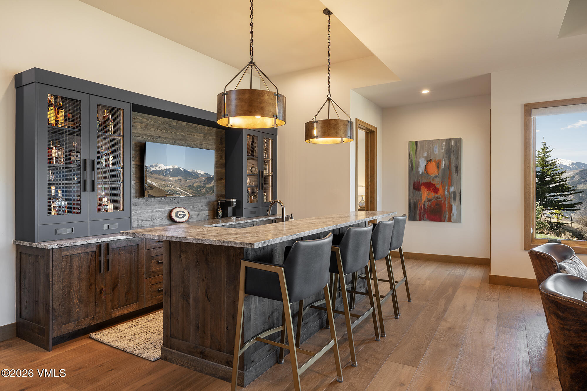 5205 Long Sun Lane Avon, CO 81620 - Photo 33 of 35 a kitchen with stainless steel appliances a dining table chairs and wooden floor