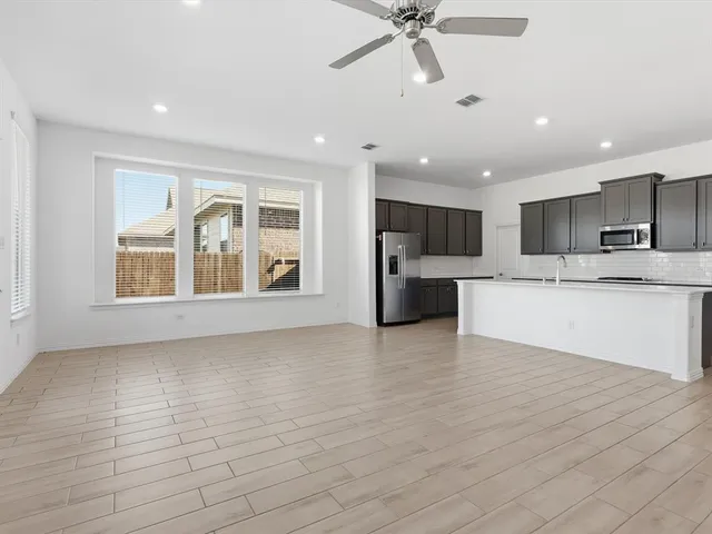 a view of a kitchen with a sink and a refrigerator