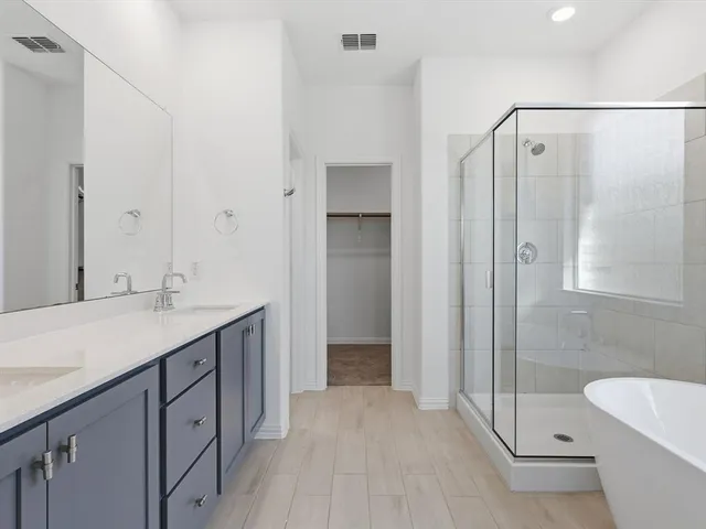 a bathroom with a double vanity sink toilet and shower