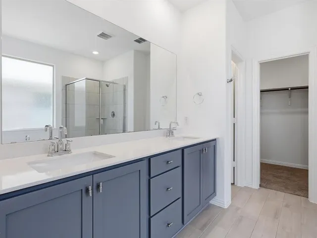 a bathroom with a double vanity sink and mirror