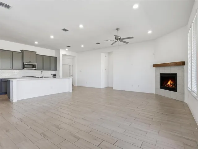 a view of kitchen with kitchen island a sink stainless steel appliances and cabinets
