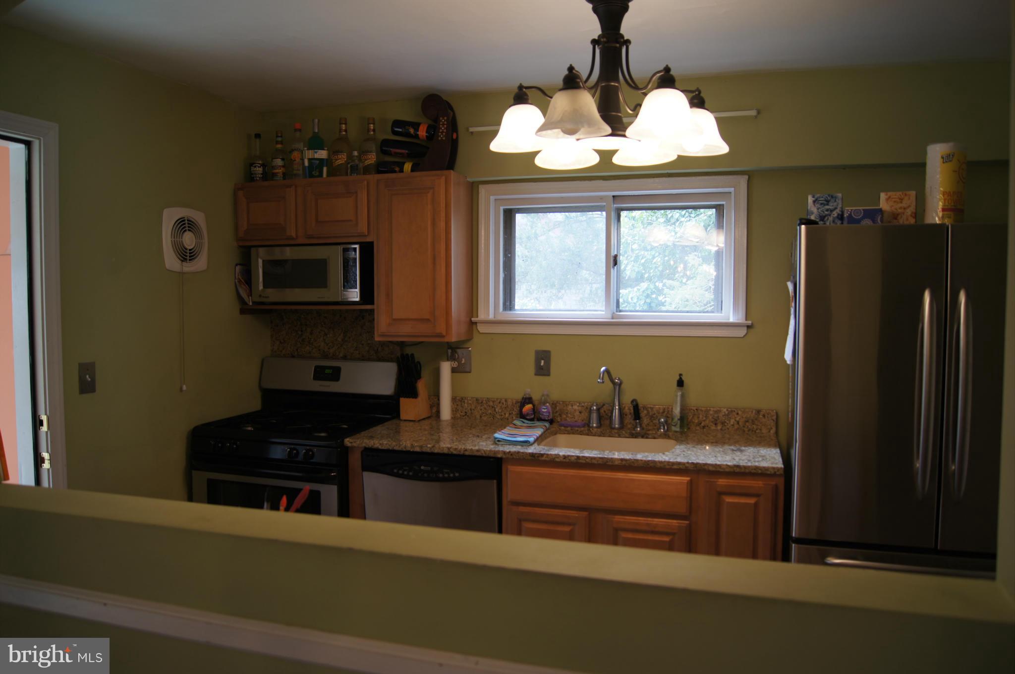 6607 Parkway Road Baltimore, MD 21239 - Photo 6 of 30 Cut out from dining room to kitchen