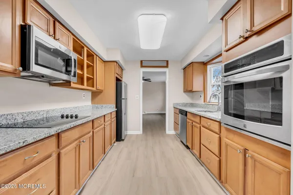 a kitchen with stainless steel appliances granite countertop a stove and a microwave