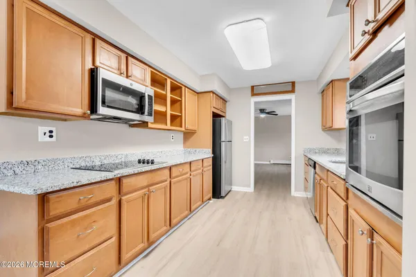 a kitchen with stainless steel appliances granite countertop a stove microwave and sink