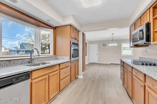 a kitchen with stainless steel appliances granite countertop a stove and a sink