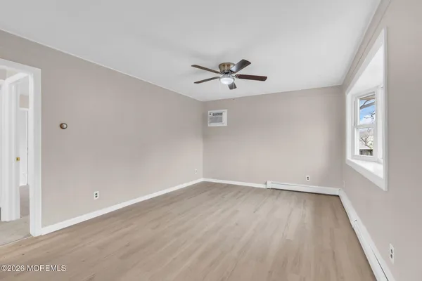 wooden floor in an empty room with a window