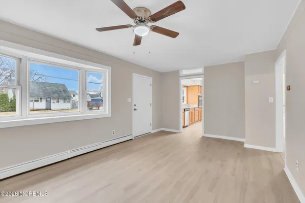 wooden floor in an empty room with a window