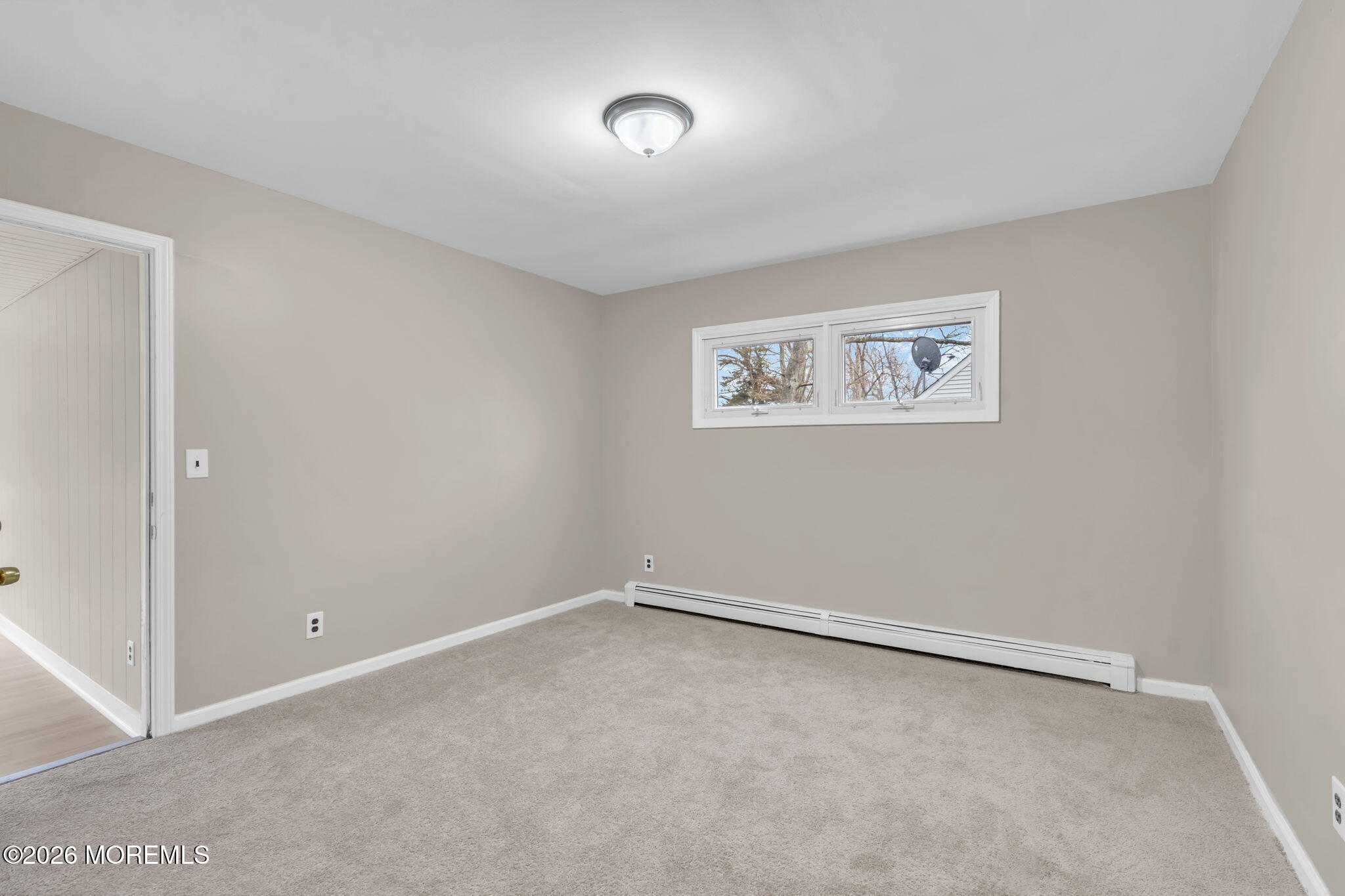 121 Harding Drive Brick, NJ 08724 - Photo 18 of 37 an empty room with a ceiling fan and window