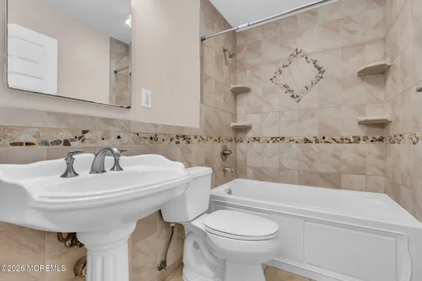 a bathroom with a sink a toilet and a bathtub