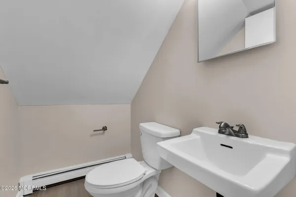 a white toilet sitting next to a bathroom sink