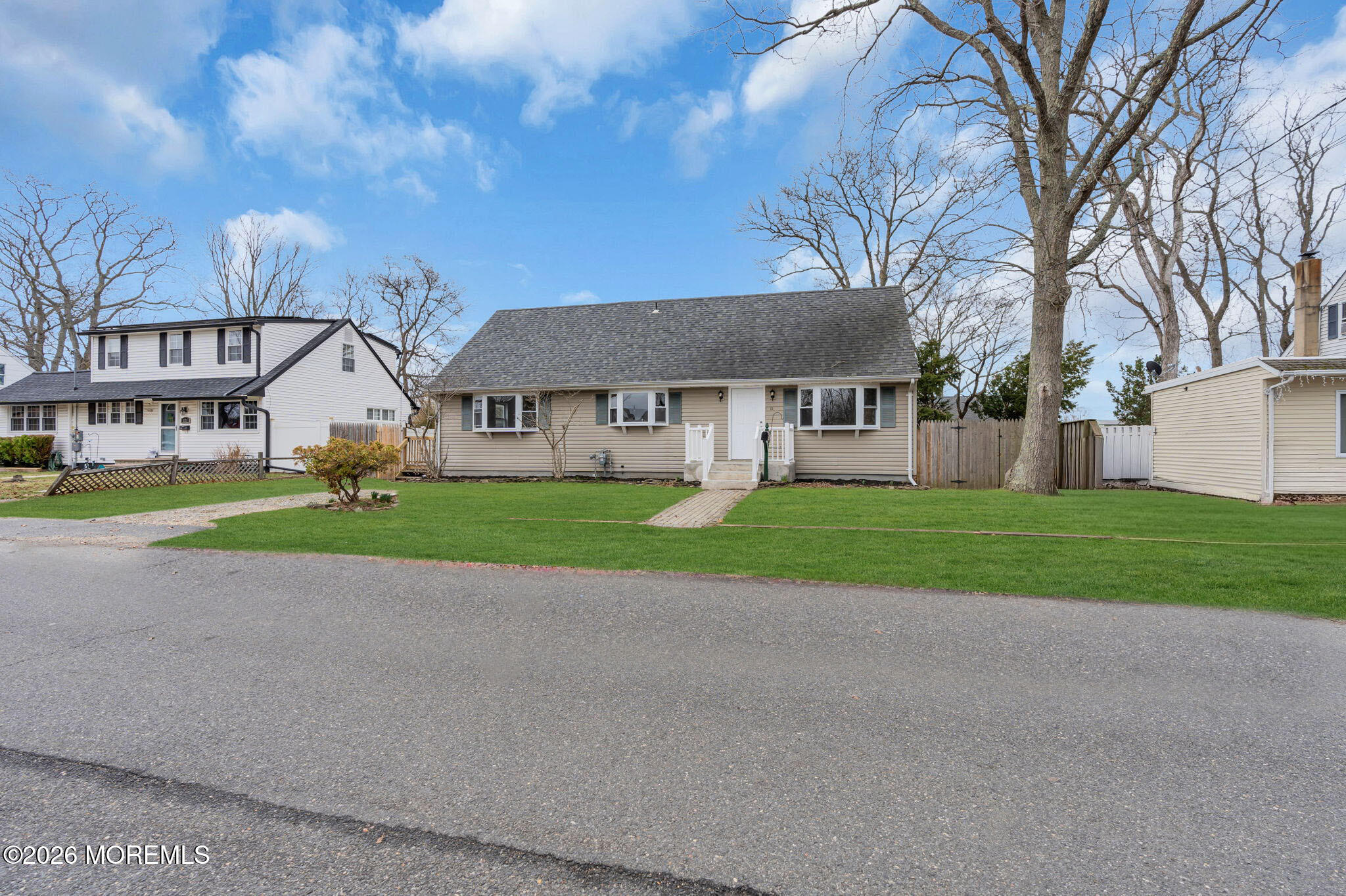 121 Harding Drive Brick, NJ 08724 - Photo 3 of 37 a view of a white house with a big yard and large trees