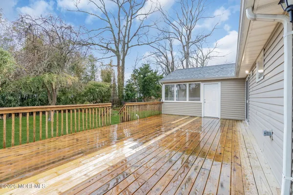 a view of backyard with a deck and wooden floor