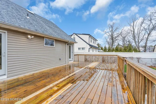 a view of balcony with wooden floor and fence
