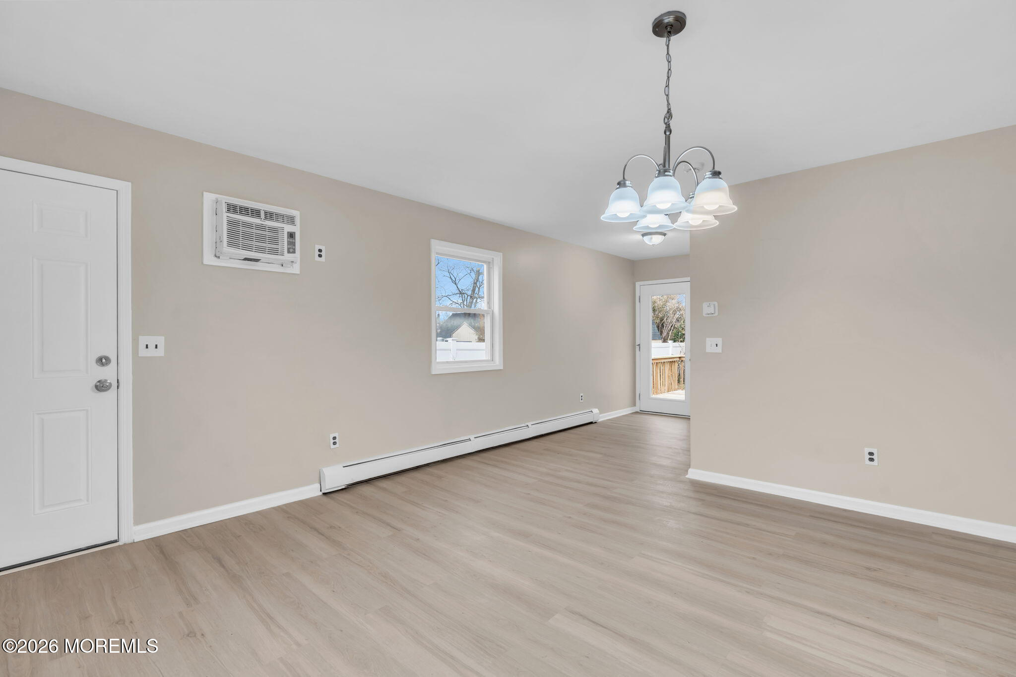 121 Harding Drive Brick, NJ 08724 - Photo 6 of 37 a view of an empty room with wooden floor and windows