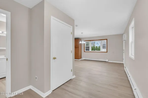 an empty room with windows and closet