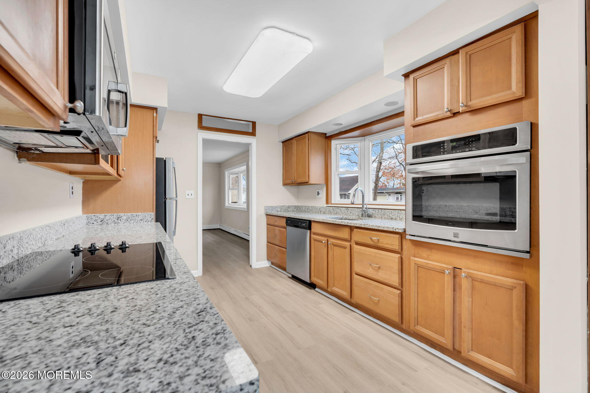 121 Harding Drive Brick, NJ 08724 - Photo 10 of 37 a kitchen with stainless steel appliances kitchen island granite countertop a stove top oven a sink and dishwasher