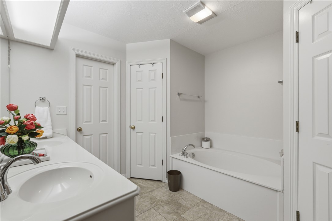 4600 Kensington Road Bryan, TX 77802 - Photo 21 of 31 Primary bathroom - standing shower and large bathtub. Two sink vanity