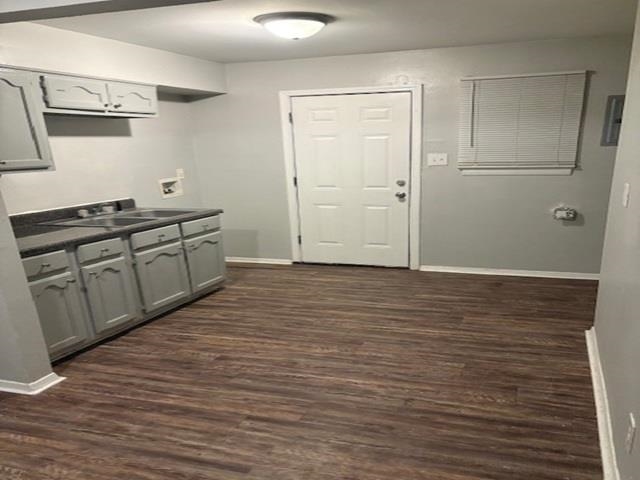 3268 Powell Avenue Memphis, TN 38112 - Photo 4 of 5 Kitchen featuring dark countertops, dark wood-style floors, gray cabinets, and electric panel