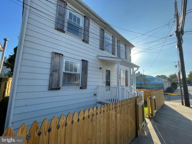 a view of a wooden house with a wooden fence