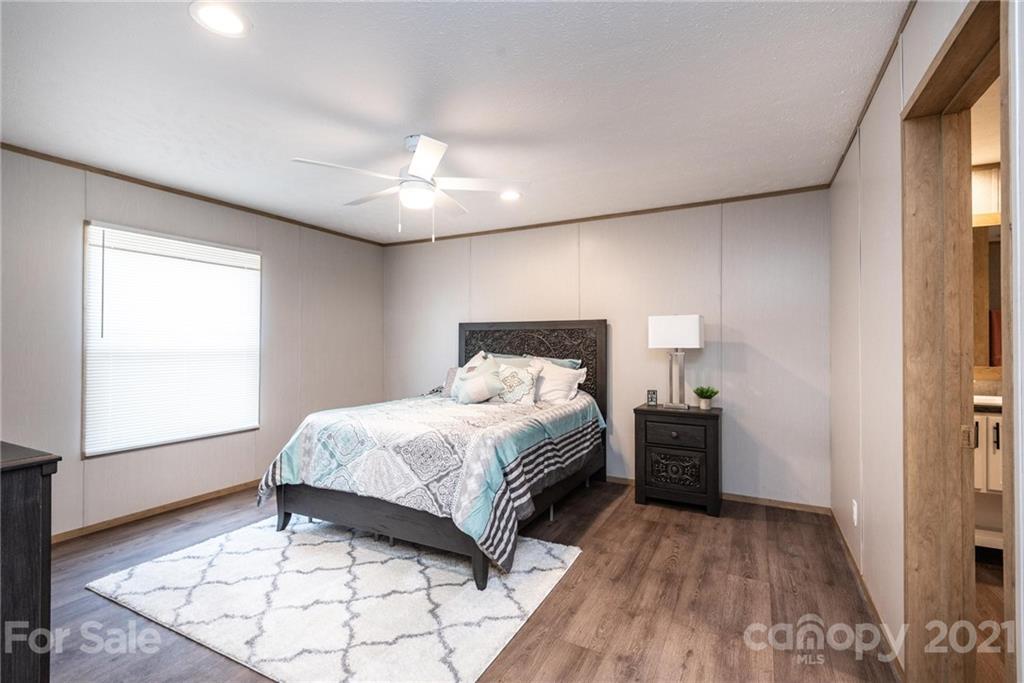 531 Stony Point School Road Stony Point, NC 28678 - Photo 40 of 47 a spacious bedroom with a bed and a window