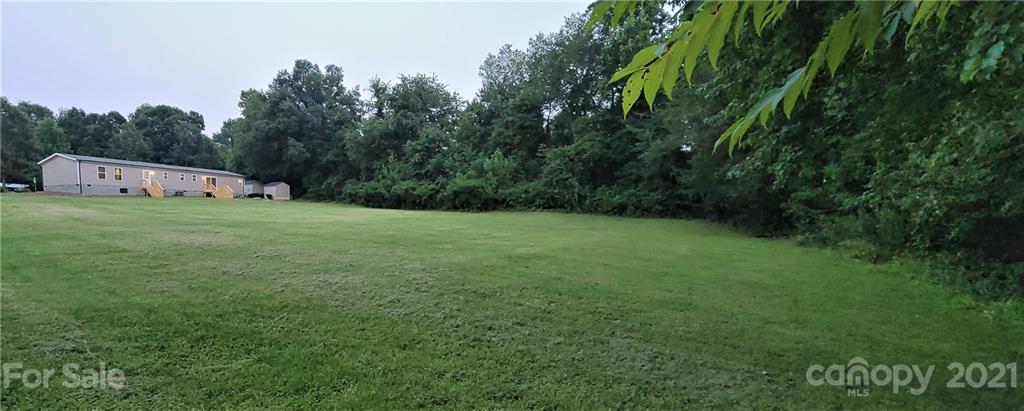 531 Stony Point School Road Stony Point, NC 28678 - Photo 5 of 47 a backyard of a house with lots of green space and trampoline