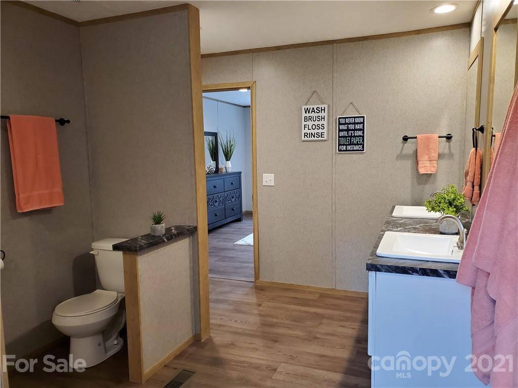 531 Stony Point School Road Stony Point, NC 28678 - Photo 46 of 47 a bathroom with a toilet sink and mirror