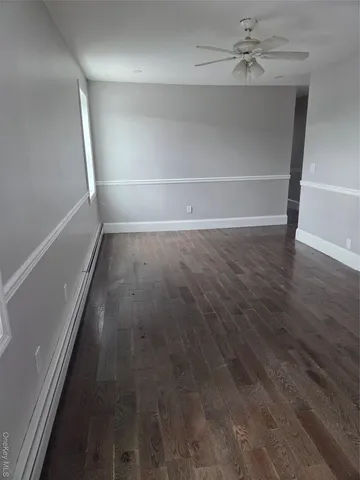 a view of a small space with wooden floor and a window