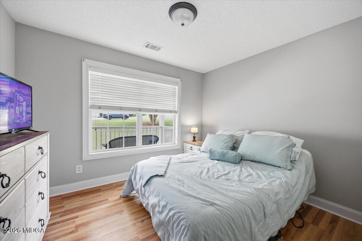 557 Aarons Circle Gray, GA 31032 - Photo 21 of 36 a bedroom with a bed and a window