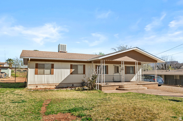 49 600 North Hurricane, UT 84737 - Photo 21 of 33 Rear view of property featuring covered porch, roof with shingles, crawl space, and a lawn